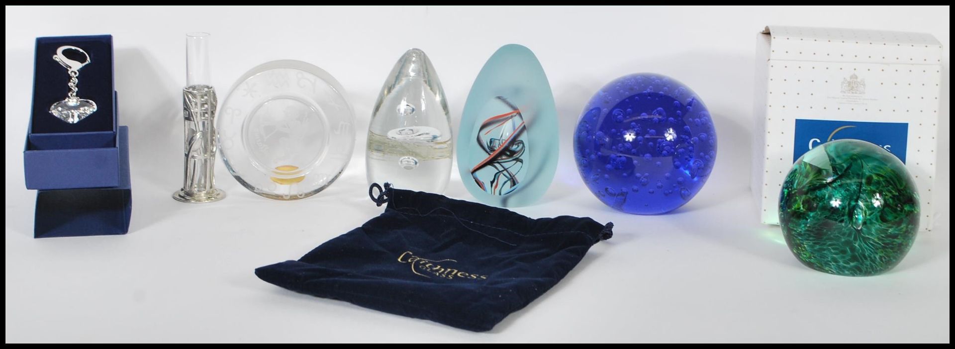 A collection of glass paperweights to include boxed Caithness in the Swirly Whirly pattern,