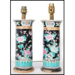 A pair of late 19th Century Chinese cylindrical ceramic vases decorated with all-over stylised