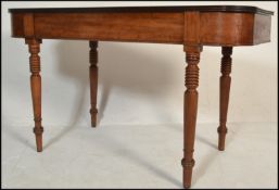 A Georgian 19th Century mahogany console hall table being raised on turned tapering legs with fitted