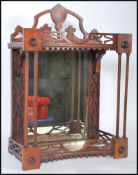 An early 20th Century wall mounted display cabinet being mahogany cased with pierced fretwork to the