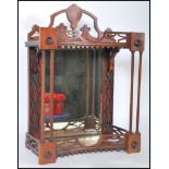 An early 20th Century wall mounted display cabinet being mahogany cased with pierced fretwork to the