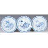 A group of three Chinese 18th Century ceramic blue and white plates all hand painted with a pagoda