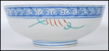 An early 20th Century Chinese footed centrepiece bowl having blue and white geometric rims, the bowl