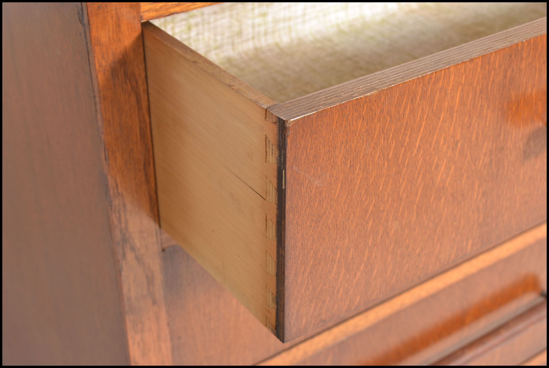 A 1930's Art Deco oak chest of drawers being raised on bracket feet with a  bank of 4 drawers having - Image 9 of 9