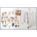 A collection of vintage costume jewellery to include predominantly brooches, bangle, pearl