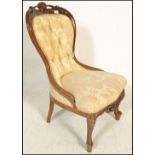 A good 20th Century walnut spoon back library armchair  being raised on walnut turned legs with