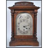 An early 20th century oak-cased eight-day quarter chime mantel clock by Kienzle, with engraved