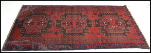 A hand knotted woolen Herati Baluchi carpet floor