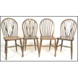 A set of four harlequin 20th Century beech and elm farmhouse dining chairs, the hoop back chairs