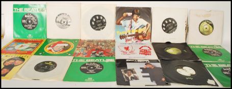 A collection of vintage 7" 45 RPM EP vinyl records to include The Beatles Singles Collection 1962-