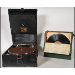 An early 20th Century portable HMV gramophone model 101 having a black leather case with a no. 4