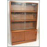 A retro 20th Century four section stacking bookcase unit by Simplex. Three section above having twin