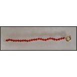 A Chinese 18ct gold and coral bracelet consisting