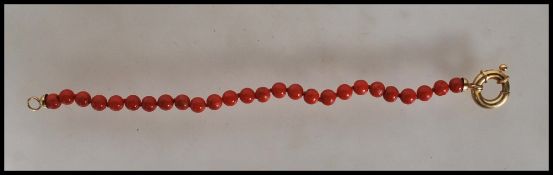 A Chinese 18ct gold and coral bracelet consisting