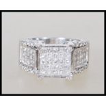 A stamped 14ct white gold and diamond ring. The he