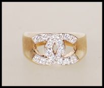 A stamped 9ct gold designer style ring with crosse