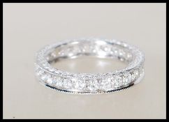 A stamped 18ct white gold and diamond full eternit