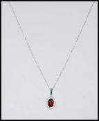 An 18ct white gold necklace pendant set with a cen