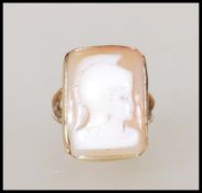 A hallmarked 9ct gold ring set with a carved recta