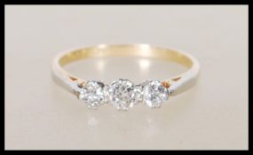 A 18ct yellow gold and platinum three stone diamon