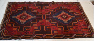 A hand knotted woolen Herati Baluchi carpet floor