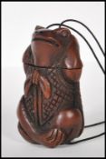 A 20th Century carved hardwood oriental toggle of