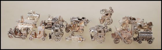 A collection of 18 silver transport related charms