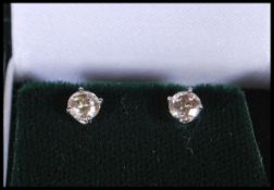 A pair of white gold and diamond single stone roun