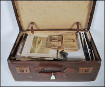 A Vintage Cowhide leather suitcase containing hund