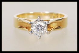 A stamped 18ct yellow gold ring having a decorativ