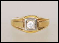 A stamped 750 18ct gold signet ring set with a rou