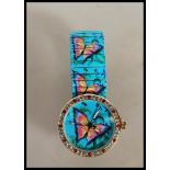 A ladies wrist watch having butterfly decoration t