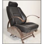 A retro 20th century car chair converted into a re