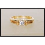 A stamped 18ct yellow gold solitaire diamond ring