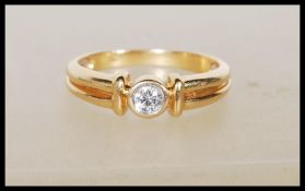 A stamped 18ct yellow gold solitaire diamond ring