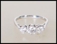 A stamped 18ct white gold and three stone diamond