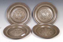 SET OF FOUR ANTIQUE PEWTER REPOUSSE CRESTED PLATES.