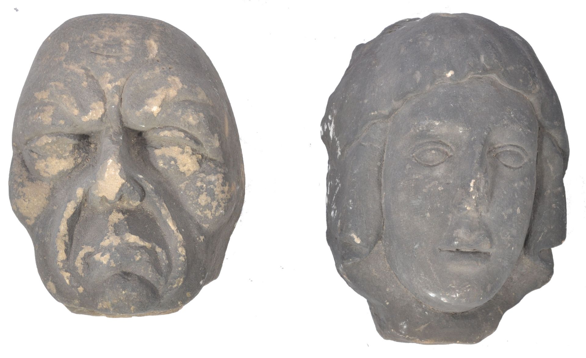 A PAIR OF EARLY CARVED STONE MEDIEVAL CARVED HEADS - CAUBLES