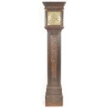 AN 18TH CENTURY CARVED OAK BRASS FACED LONGCASE CLOCK