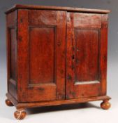 A 17TH CENTURY CARVED OAK SPICE CUPBOARD / CABINET