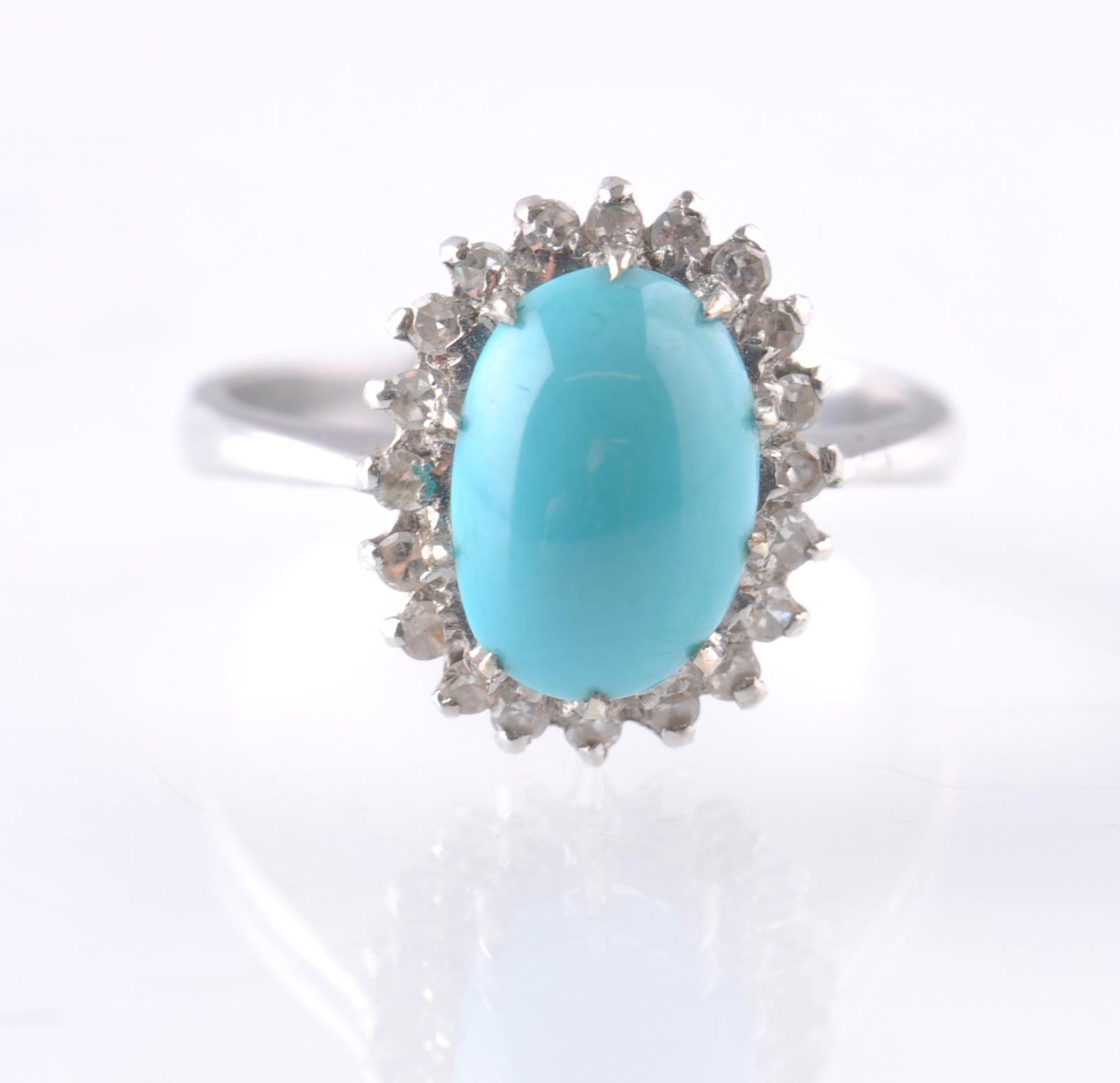 AN 18CT WHITE GOLD TURQUOISE AND DIAMOND OVAL CLUSTER RING