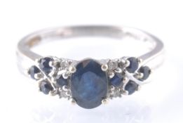 A HALLMARKED 9CT GOLD SAPPHIRE AND DIAMOND RING