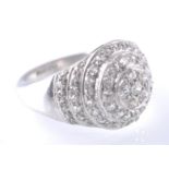A PLATINUM AND DIAMOND GRADUATED ROUNDEL CLUSTER RING