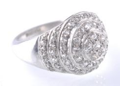 A PLATINUM AND DIAMOND GRADUATED ROUNDEL CLUSTER RING