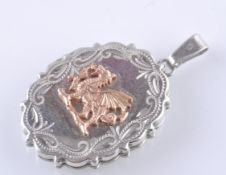 A SILVER HALLMARKED AND GOLD OVAL LOCKET