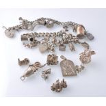 TWO VINTAGE SILVER CHARM BRACELETS WITH ADDITIONAL LOOSE CHARMS