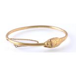 AN ANTIQUE OUROBOROS GOLD AND RUBY SNAKE BANGLE