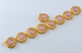 A GOLD FILIGREE AND PINK STONE BRACELET WITH PIN