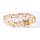 A GOLD FANCY LINK WHITE STONE SET BRACLET