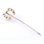 9CT GOLD RUBY AND DIAMOND HORSE SHOE STICK PIN